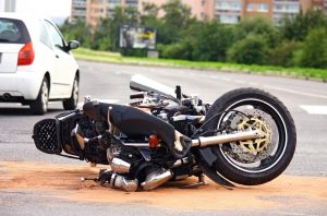 motorcycle on ground after accident with car