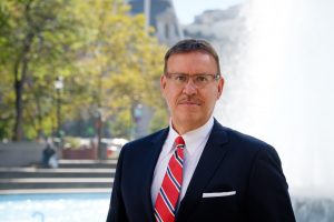 Portrait photo of Rand Spear Accident Attorney in front of fountain in front of Philadelphia City Hall