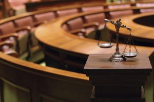 empty courtroom with scales of justice