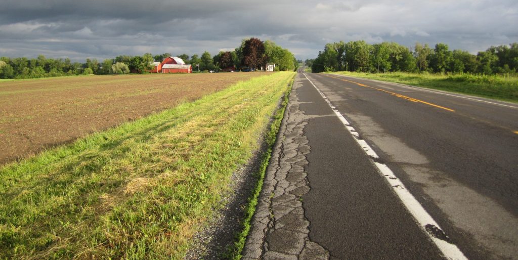 rural road with farm and fields