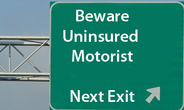 beware of uninsured motorist next exit highway sign