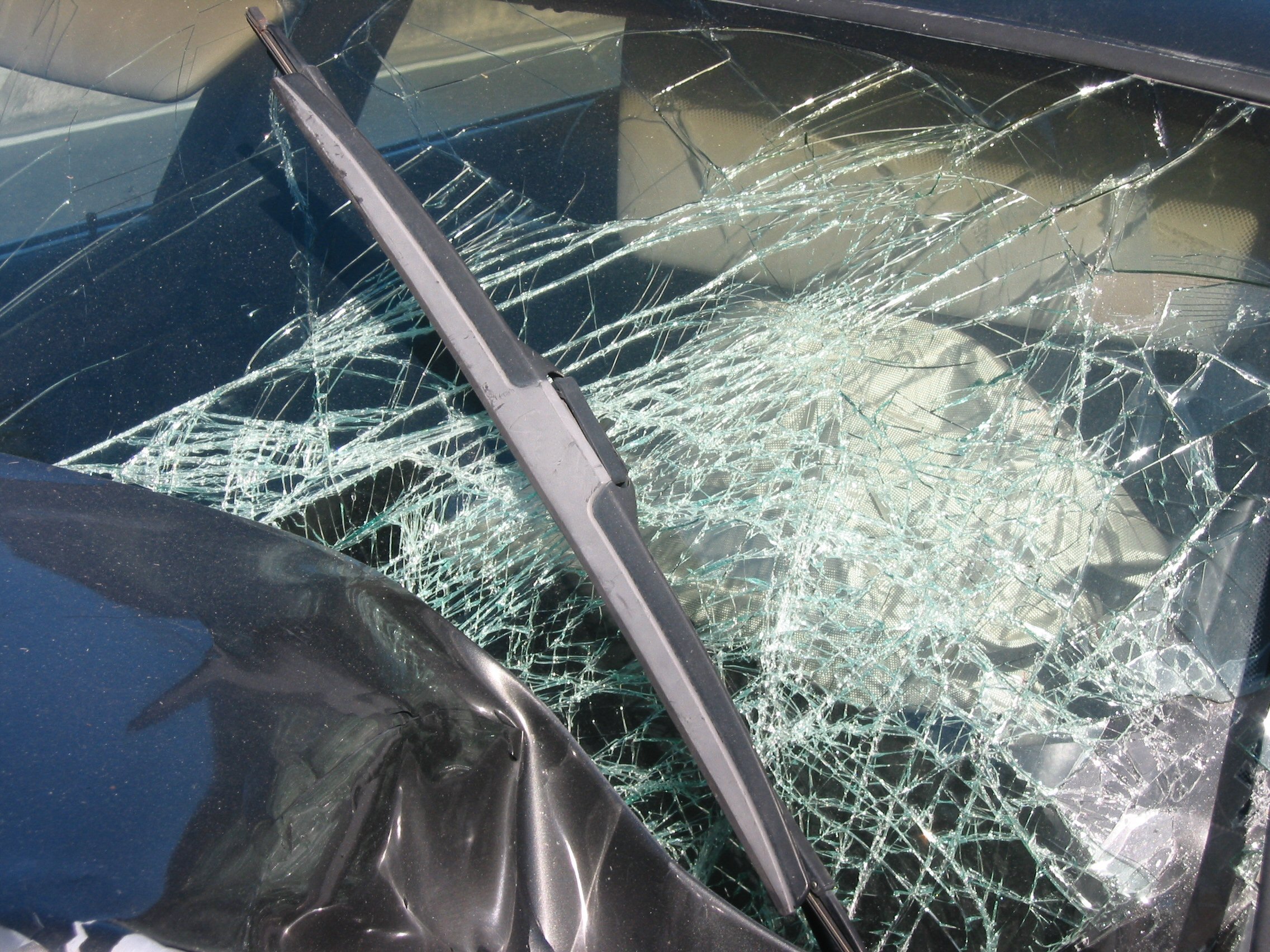 windshield with broken glass after car accident