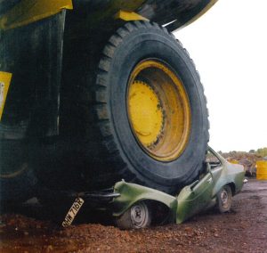 car crushed under giant wheel