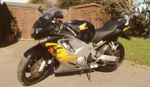 black grey and yellow motorcycle parked outside in driveway