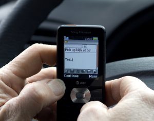 driver texting while behind the wheel