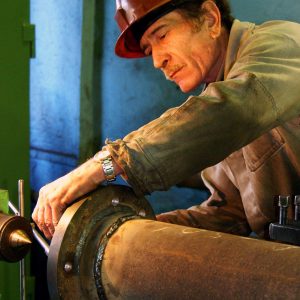 metal worker working on pipe