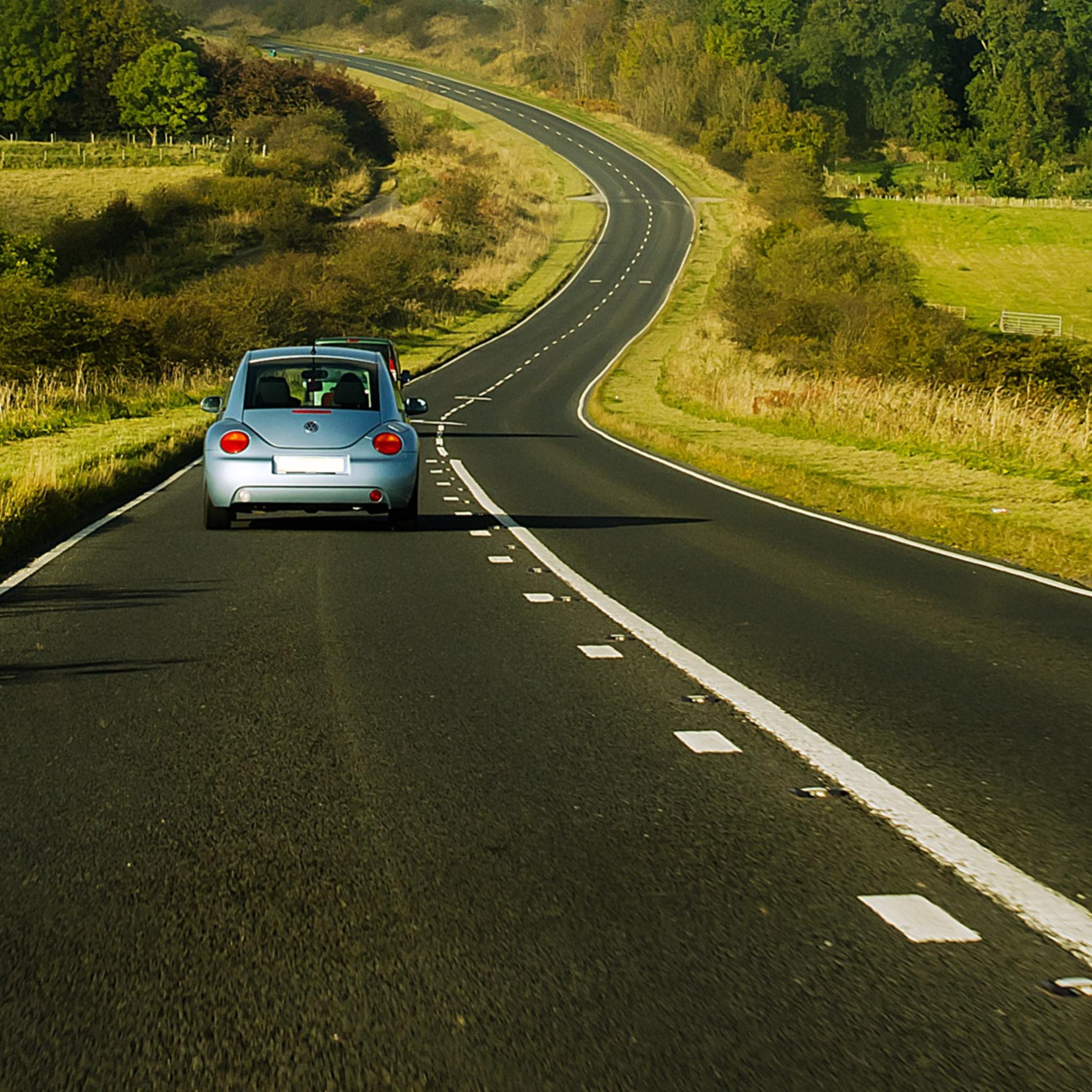 vw bug driving on rural road