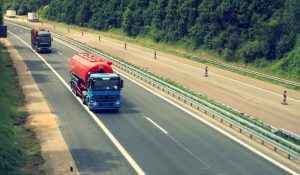 two semi trucks driving on highway road