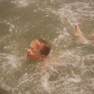 young boy drowning while trying to swim