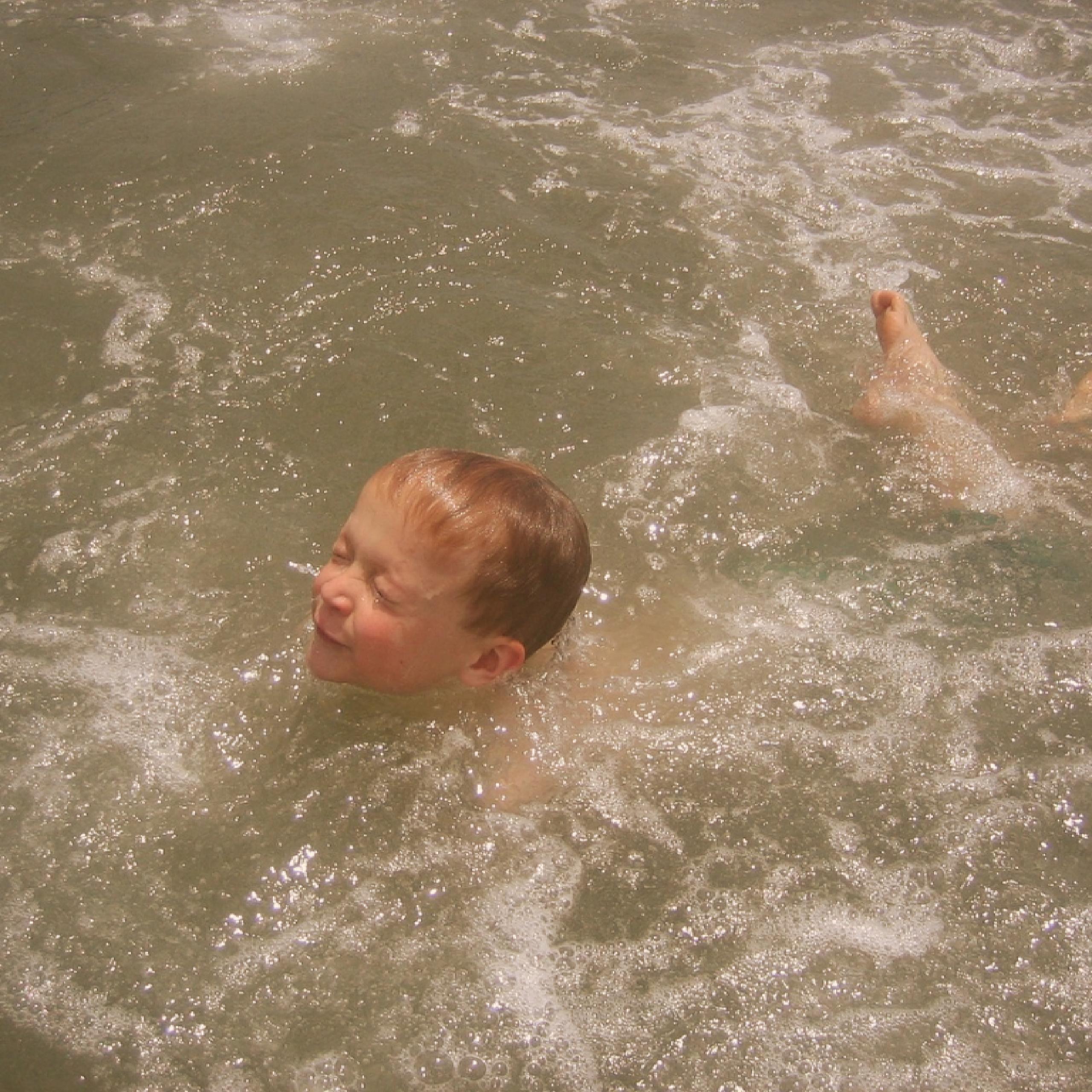 young boy drowning while trying to swim