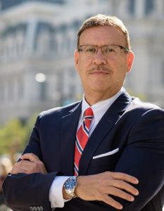 Portrait photo of Rand Spear Accident Attorney with arms crossed in front of Philadelphia City Hall