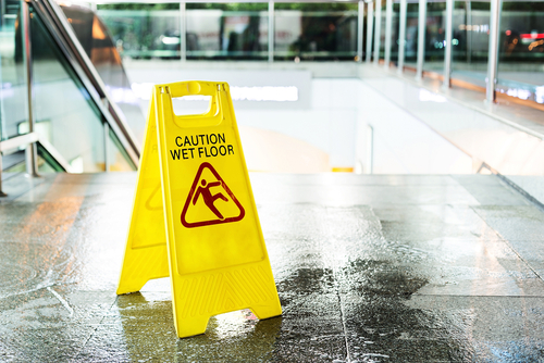 caution wet floor sign in commercial building before stairs