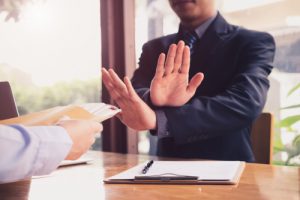 man disagreeing with crossed hands