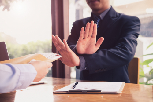 man disagreeing with crossed hands