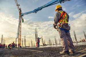 construction workers on rooftop with crane