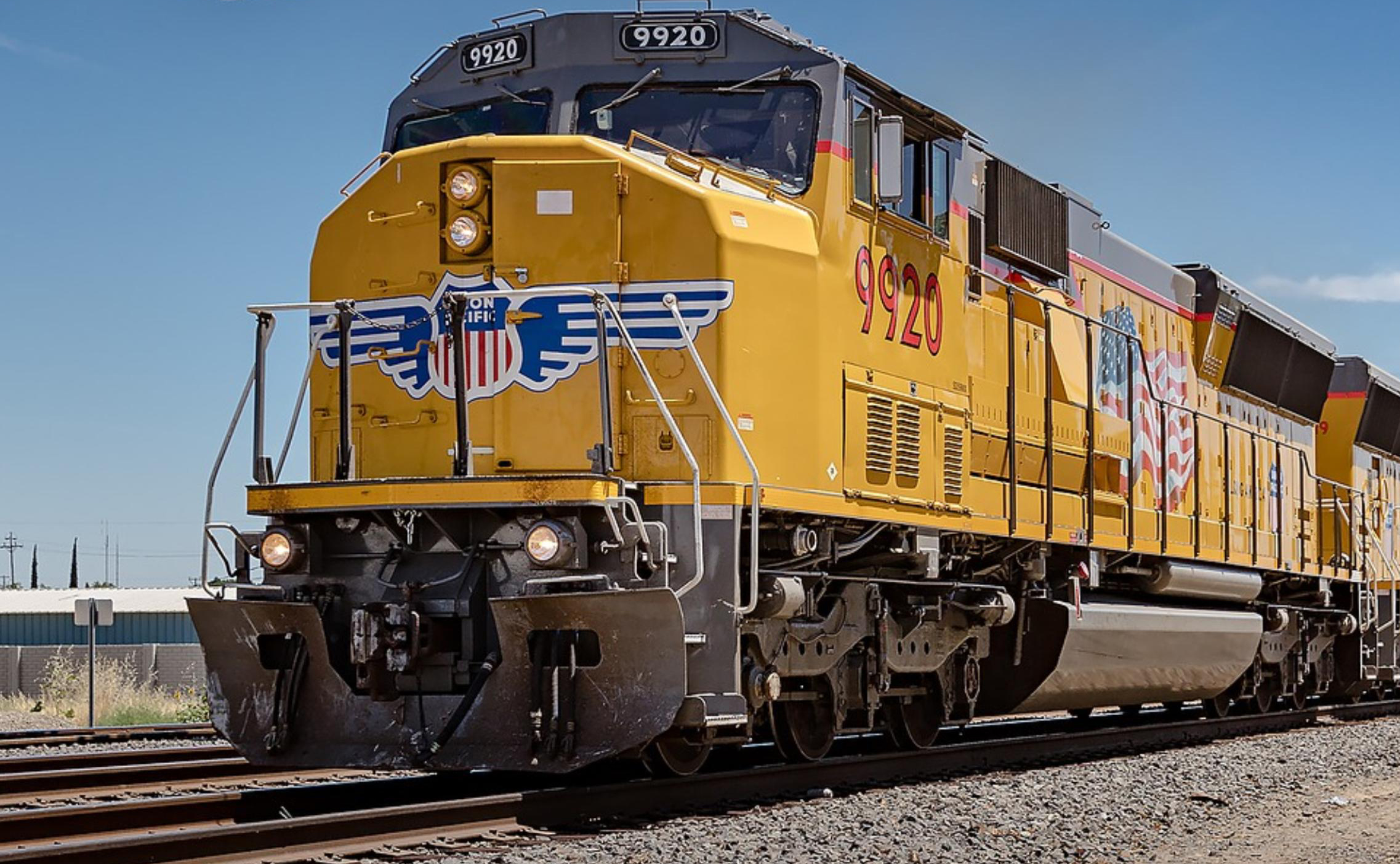 yellow Union Pacific freight train on tracks