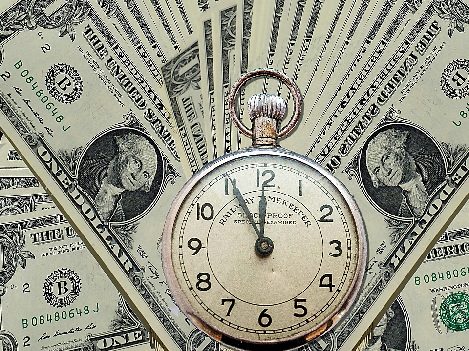 dollar bills and old time piece