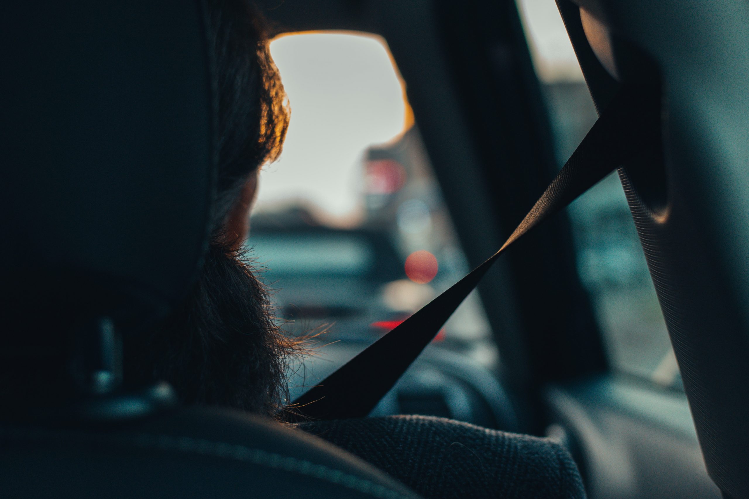 close up of car front seat passenger wearing seatbelt