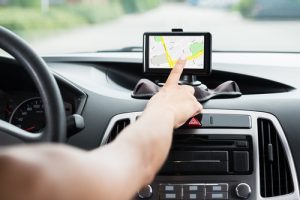 close up of driver changing gps while driving