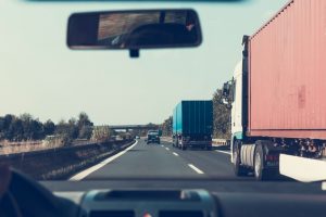 drivers view of driving on road with semi trucks