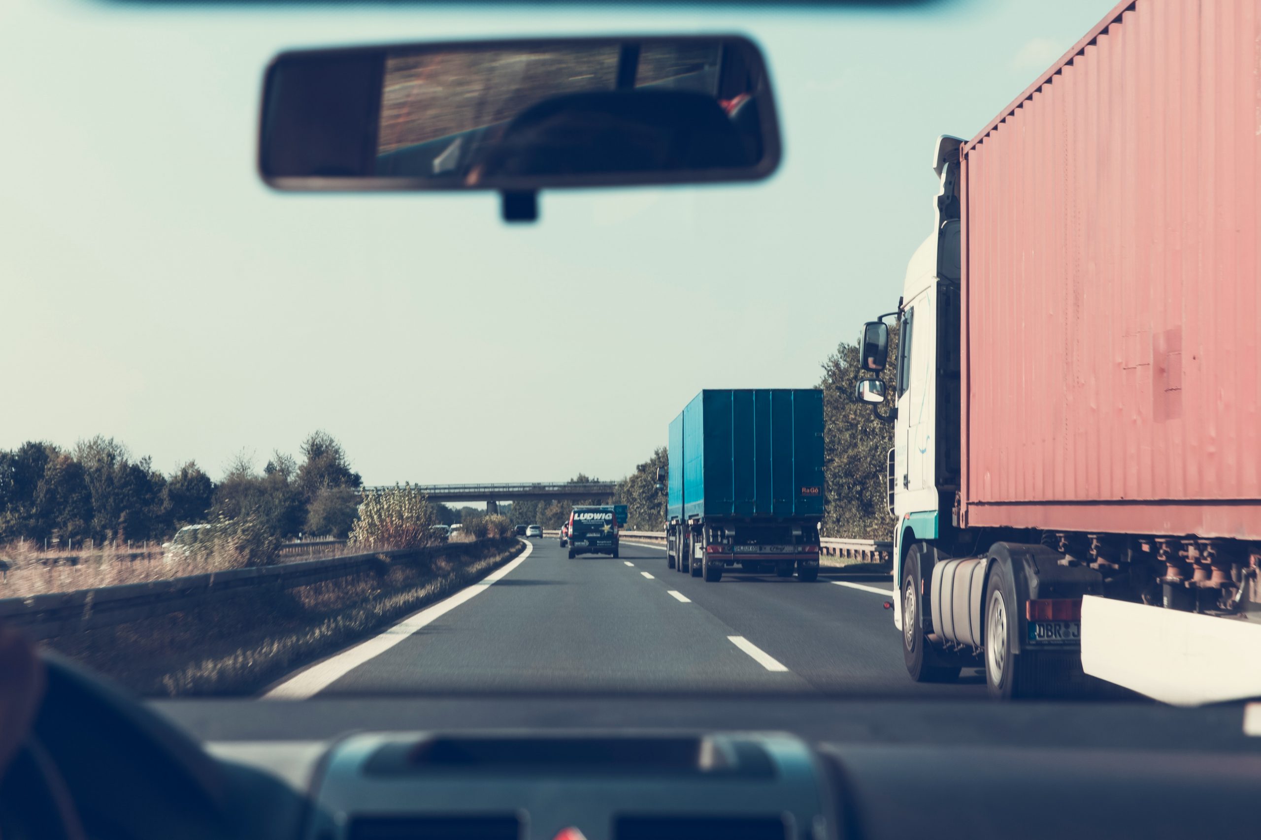 drivers view of driving on road with semi trucks