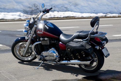parked motorcycle with snow in background