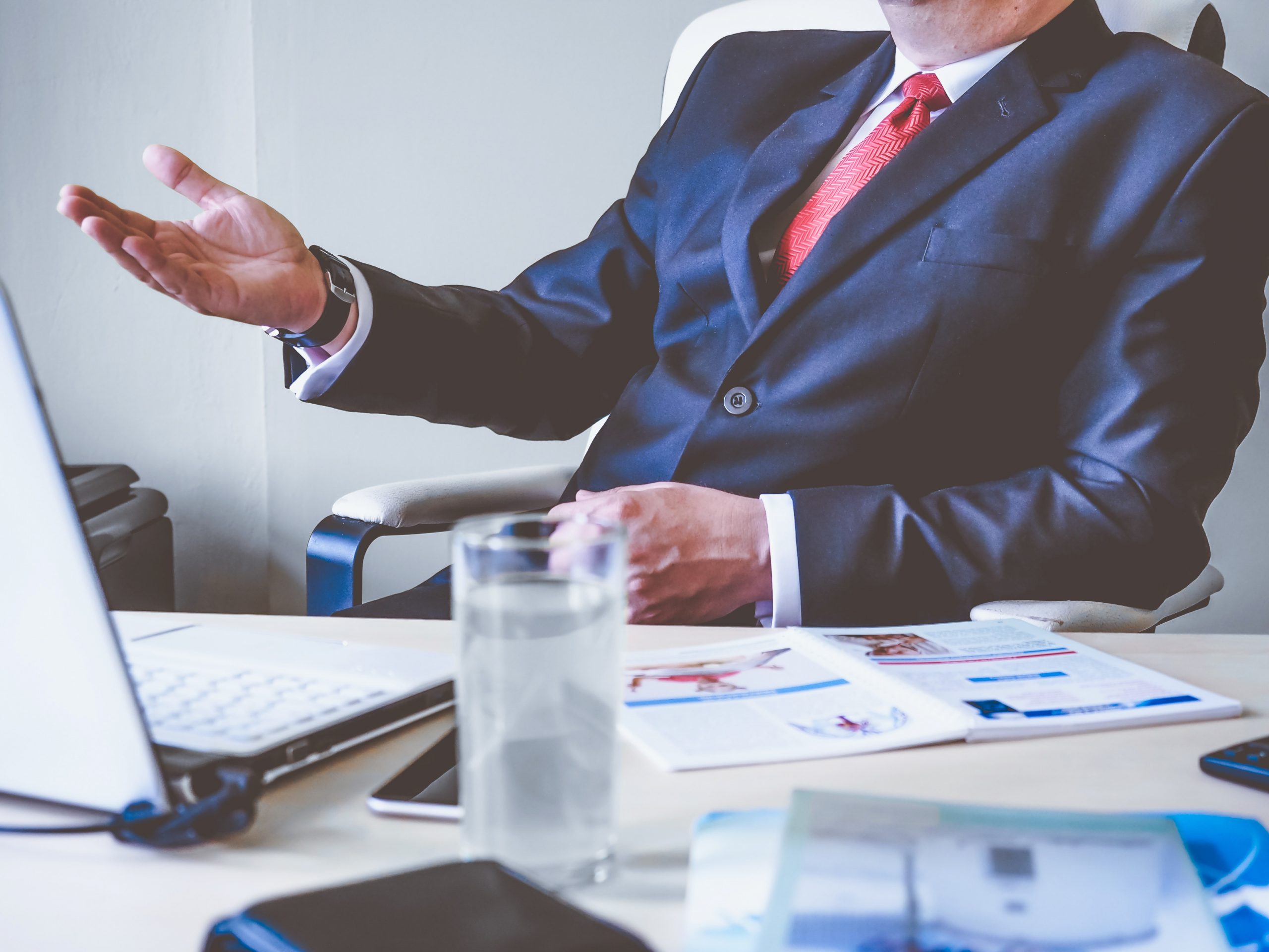 close up of man in business suit at office desk