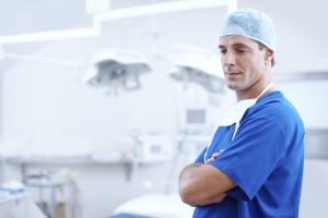 male doctor with arms crossed in surgical suite