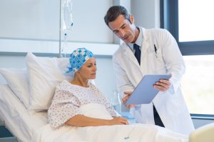 male doctor speaking with female cancer patient