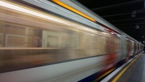 blurred motion photo of subway train leaving station