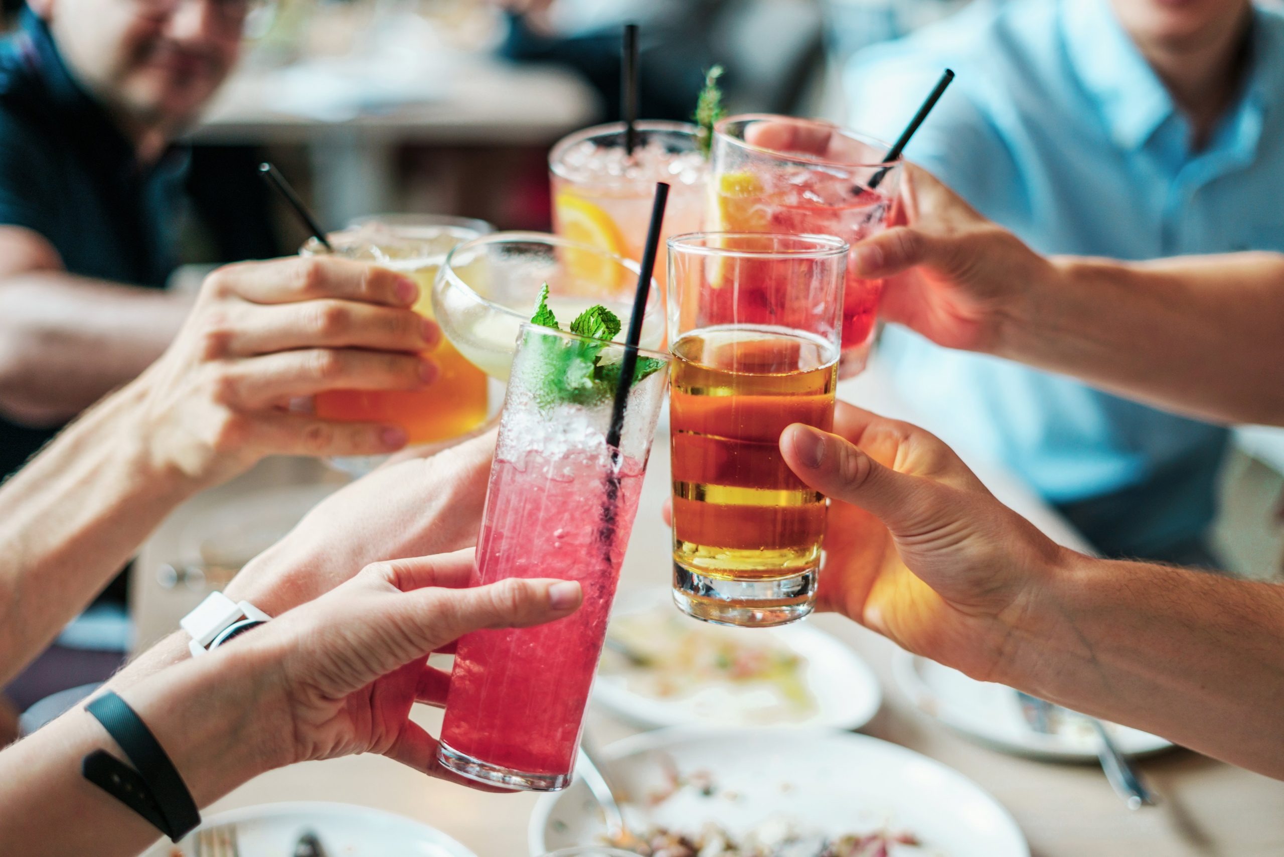 group of people doing cheers with alcoholic beverages