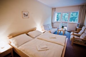 hotel room with bed and sofas