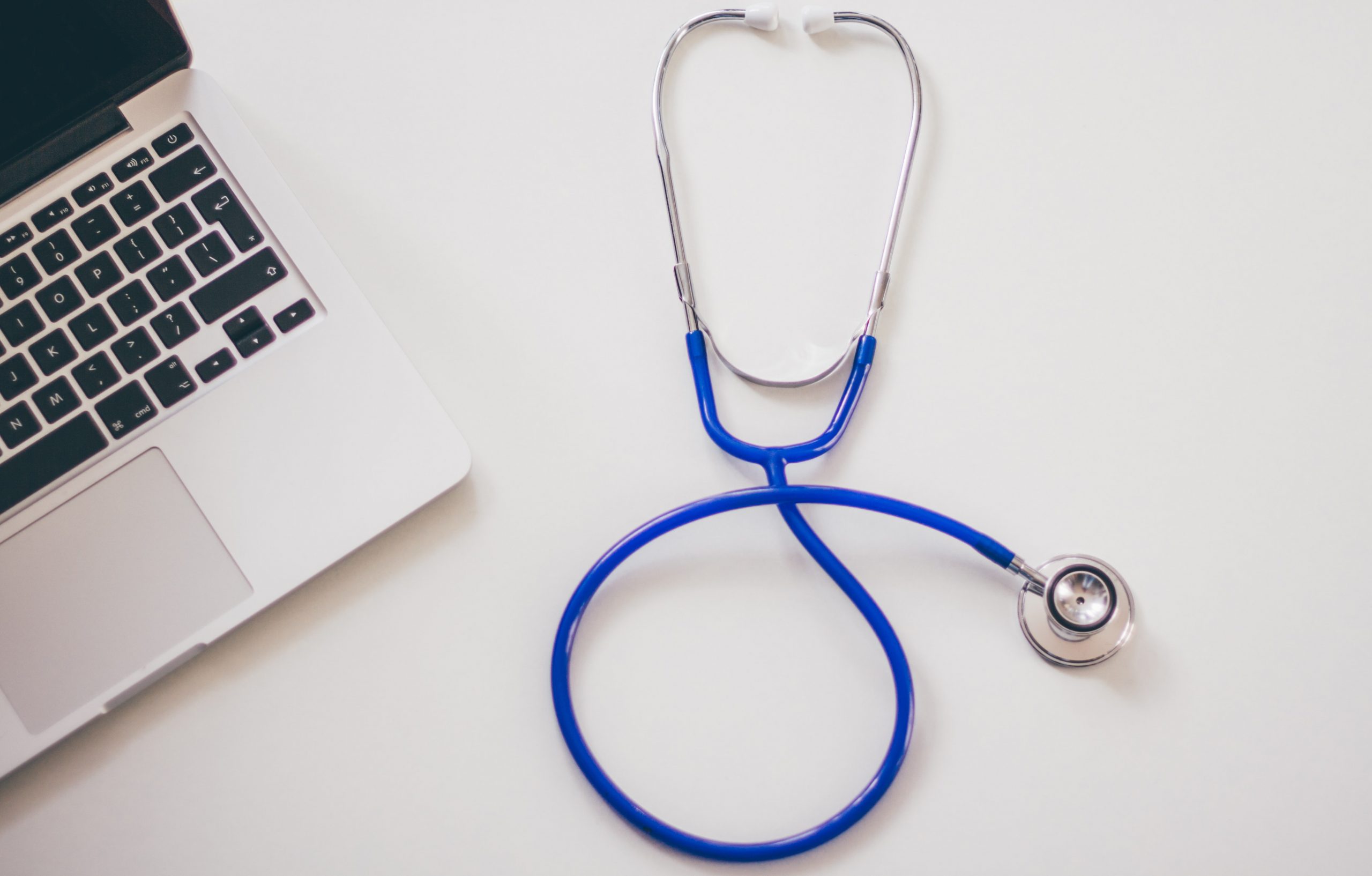 close up of laptop computer and stethoscope