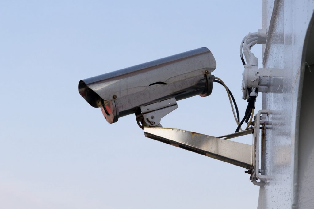 close up of silver security camera on metal structure