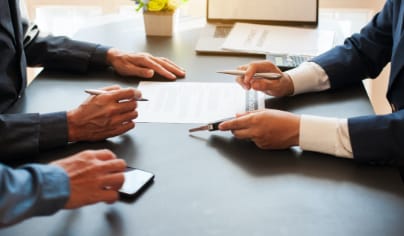 close up of hands and papers during accident claim settlement