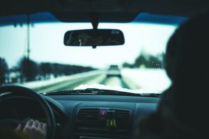drivers view out windshield of driving in the winter