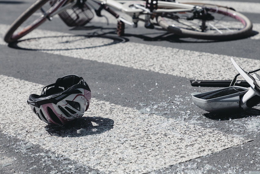 bicycle and helmet on ground after accident