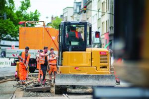 group of road construction workers working outside during the summer