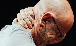 man suffering from neck pain after accident
