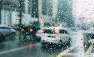 cars driving in city in rain