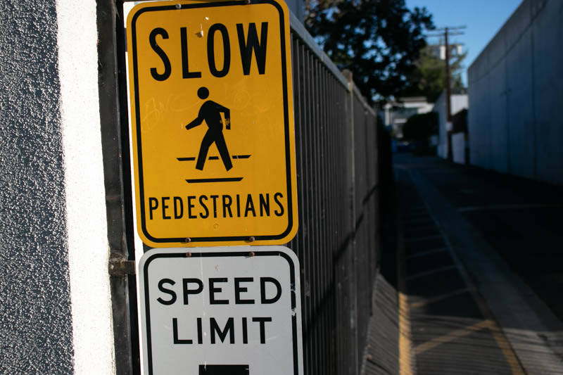 slow pedestrians and speed limit signs