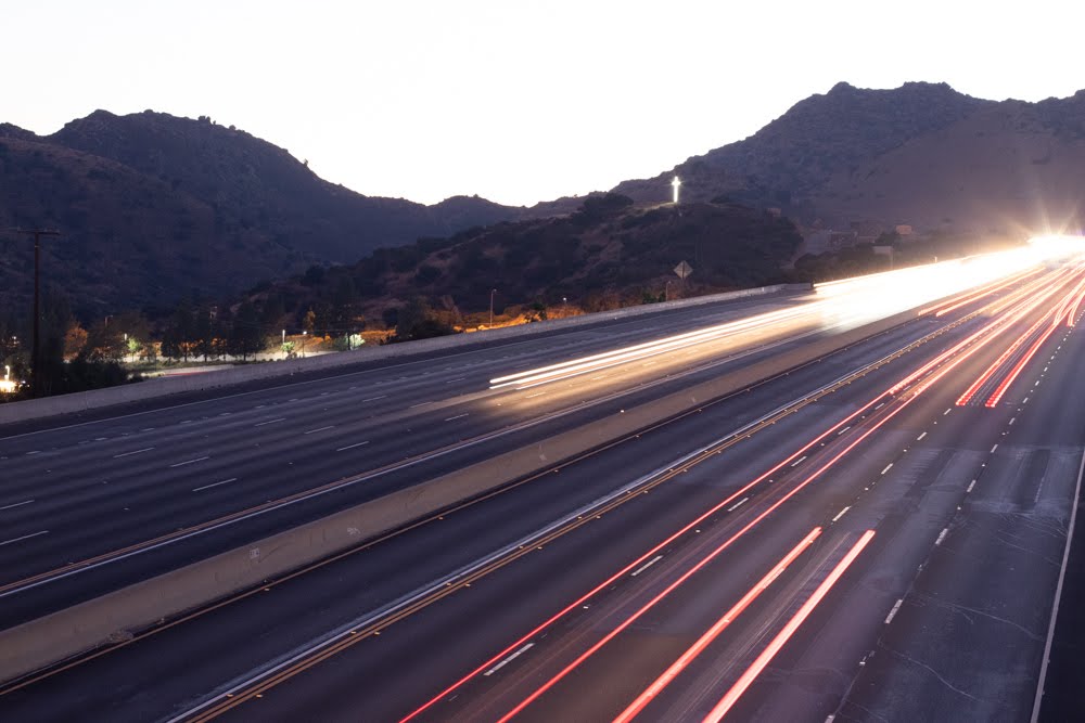 light trails from car headlights and taillights on aa highway at dusk