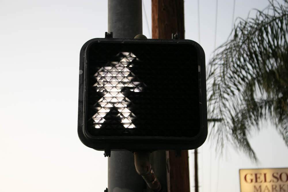 cross walk light lit up to walk symbol