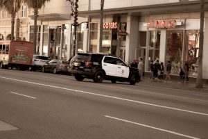 police car outside of miniso and hooters