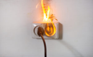 An electrical outlet catches on fire from a short circuit. Learn how product liability lawyers can help you recover compensation.