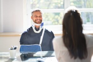 injured-man-looking-hopeful-while-working-with-lawyer
