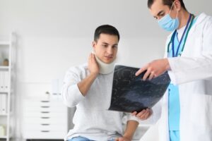 young man with neck injury visiting doctor
