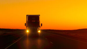 semi-truck driving at sunset
