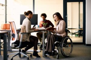 young woman in wheelchair meeting with others