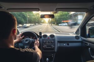 view of a rideshare driver from the backseat